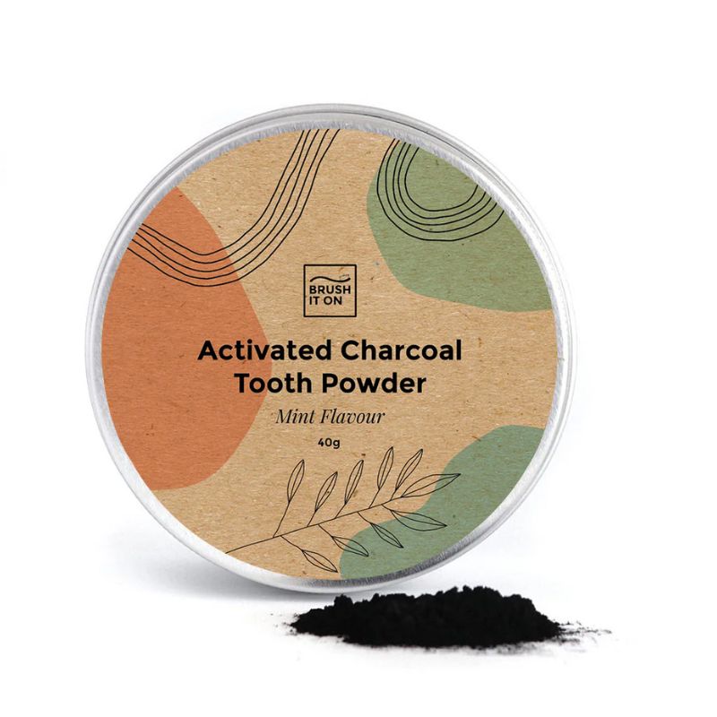 Brush It On - Activated charcoal tooth powder - showing tin with some powder next to it. 
