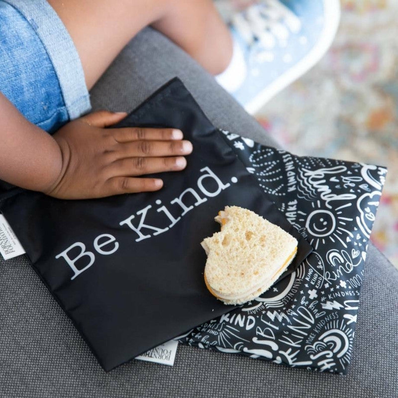 Bumkins reusable sandwich bags - set of 2 - Be Kind - next to child. 