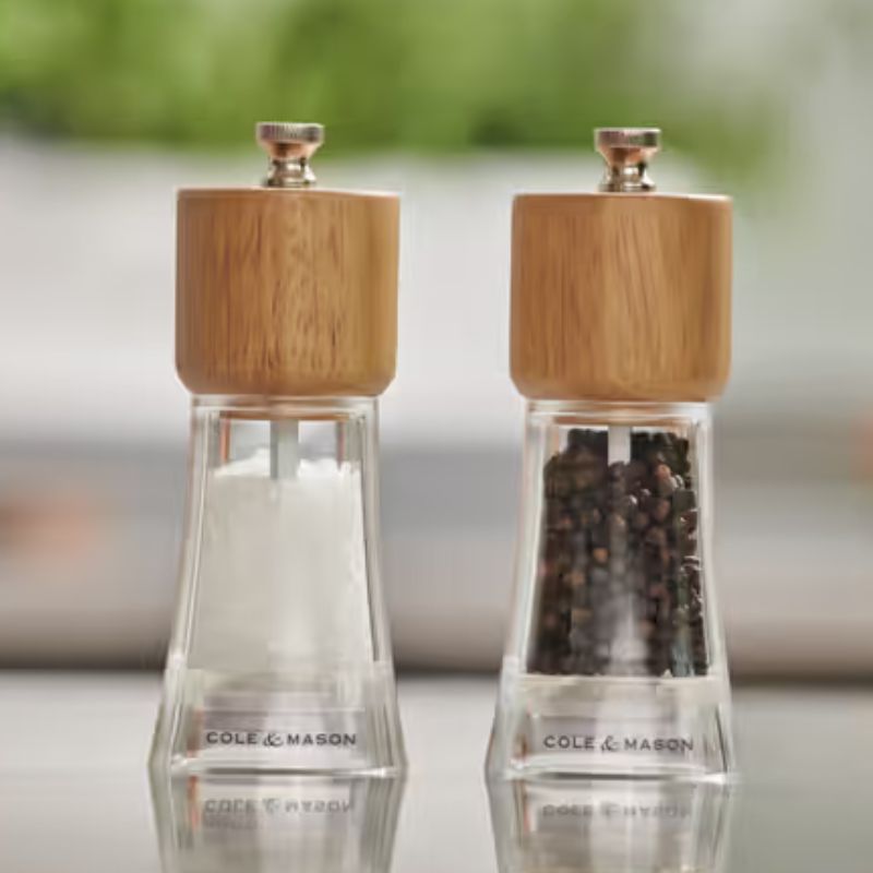 Cole and Mason Woodbury gift set - reusable salt and pepper grinders on a table.