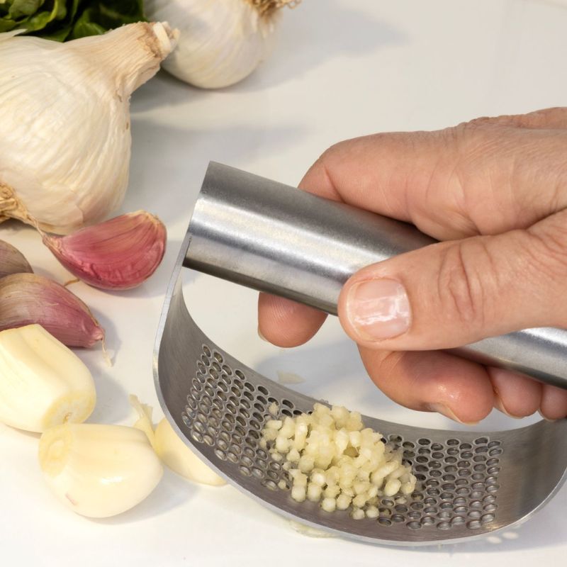 Cuisena Stainless Steel Garlic rocking press - shown in use. 