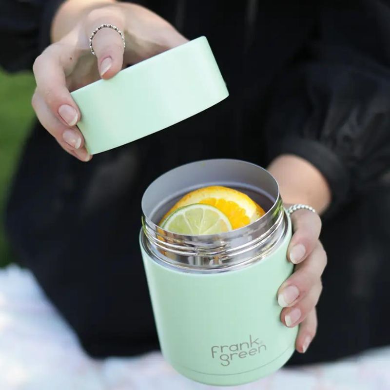 Frank Green Insulated Food Container 16oz 475ml - in Mint Gelato - woman showing it without lid and with food. 