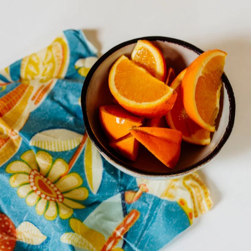Honeybee Wrap - beeswax wrap - single size medium - shown with a bowl of cut oranges. 