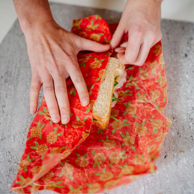 Honeybee Wrap - single bees wax wrap - sandwich being wrapped. 