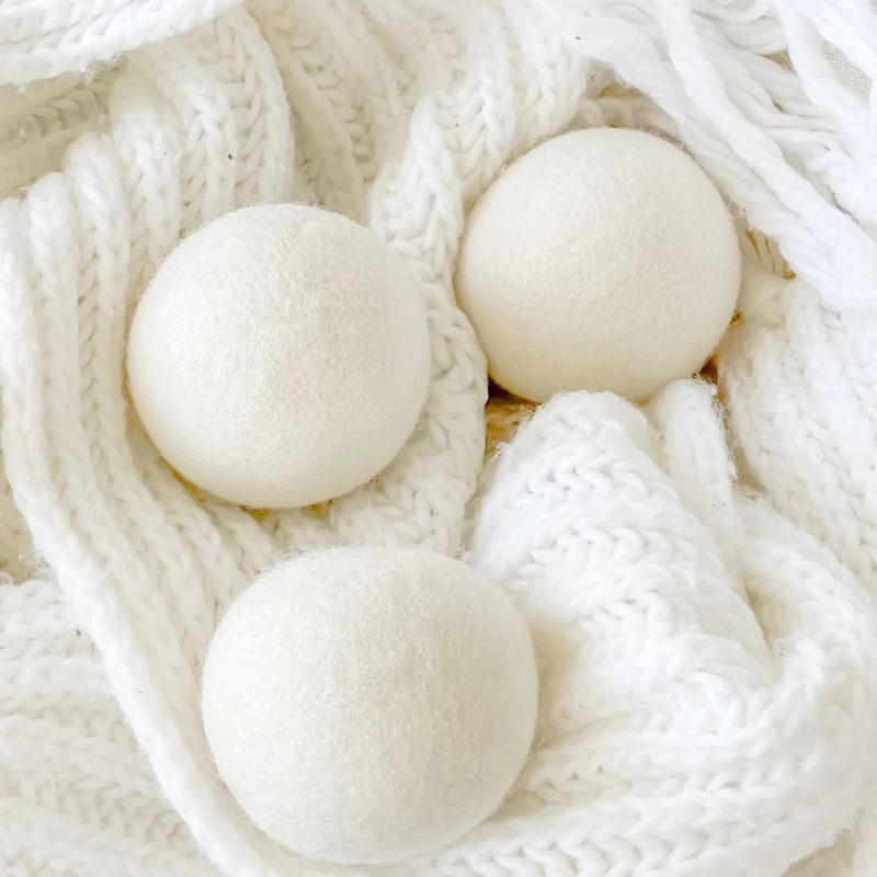 Notre.Co dryer balls - 200% Australian wool - set of 3 shown on a knitted scarf.
