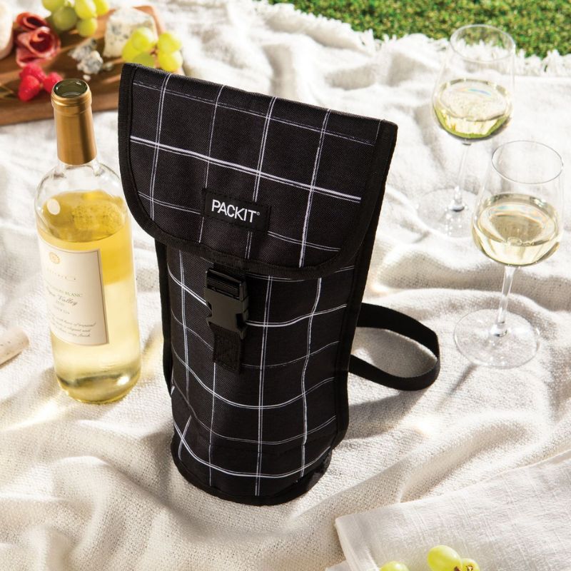 PackIt freezable Napa Wine Bag - Black Grid - on picnic blanket with bottle and glasses.