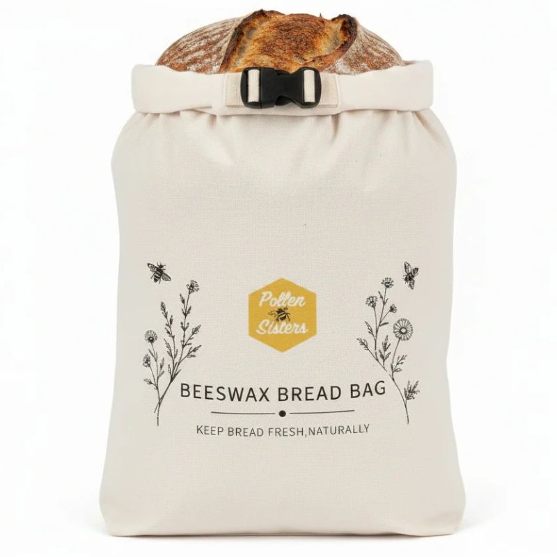 Pollen Sisters beeswax bread bag - large size - showing with sourdough bread sticking out at the top of the bag.