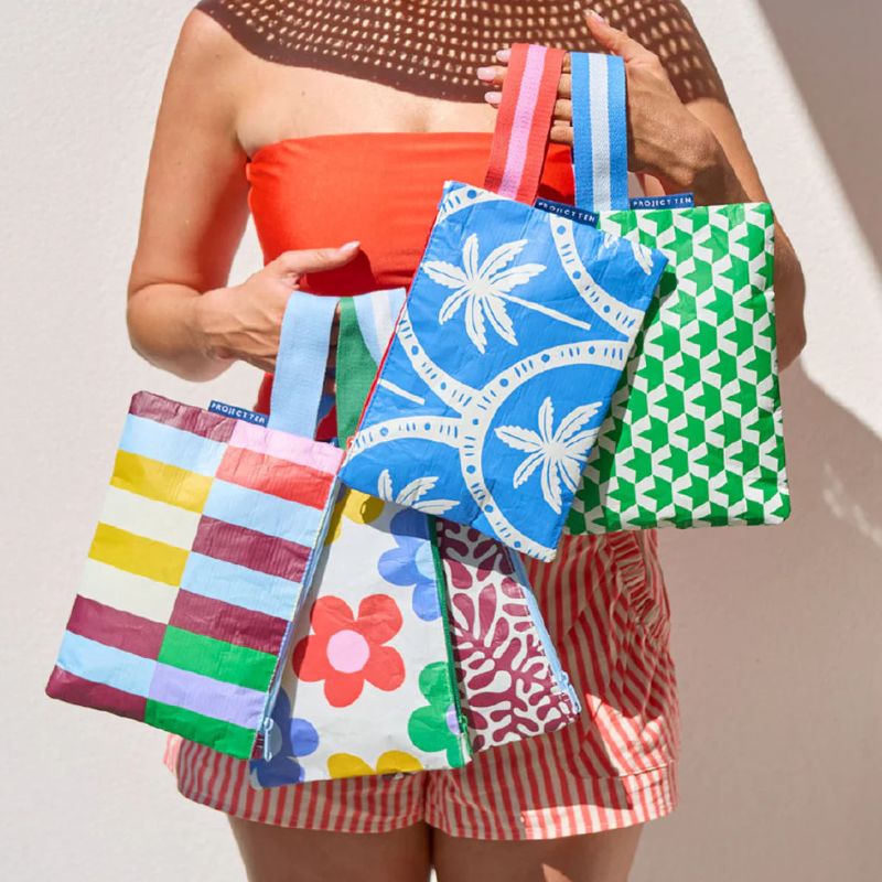 Project Ten mini zip pouch - woman holding a mix of pouches.