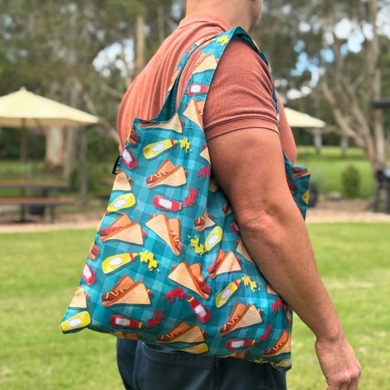 Ruby Olive reusable shopping bag made from recycled plastic bottles - bag hanging on a man's shoulder.