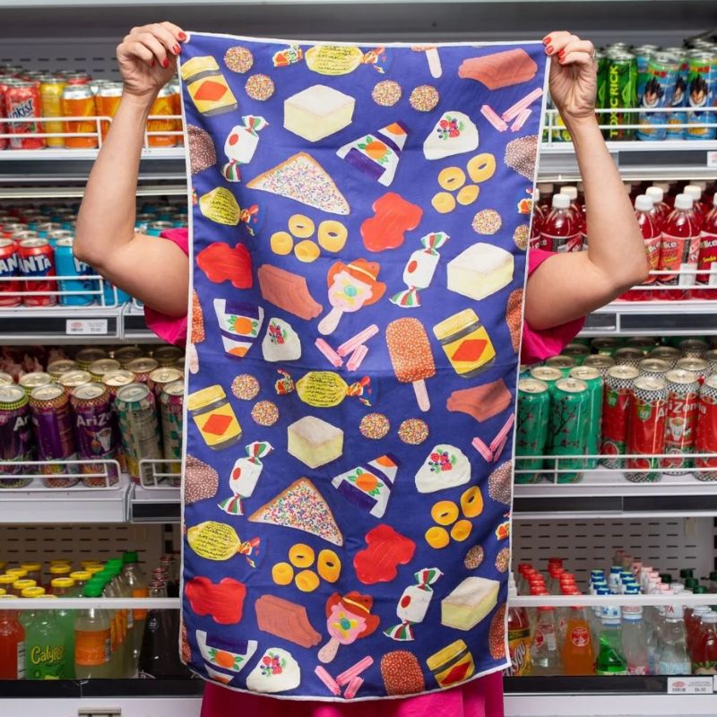 Ruby Olive - small gym towel - woman holding up one of the Aussie Fav towels.