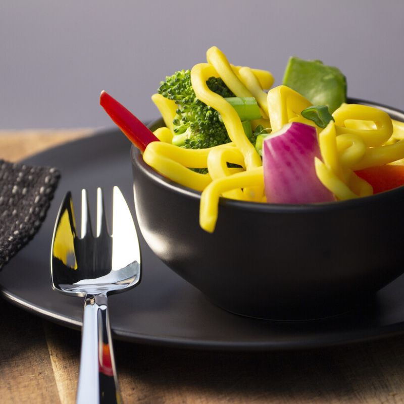 Splayd original stainless steel mirror set of 2 - showing a Splayd next to a bowl of food. 