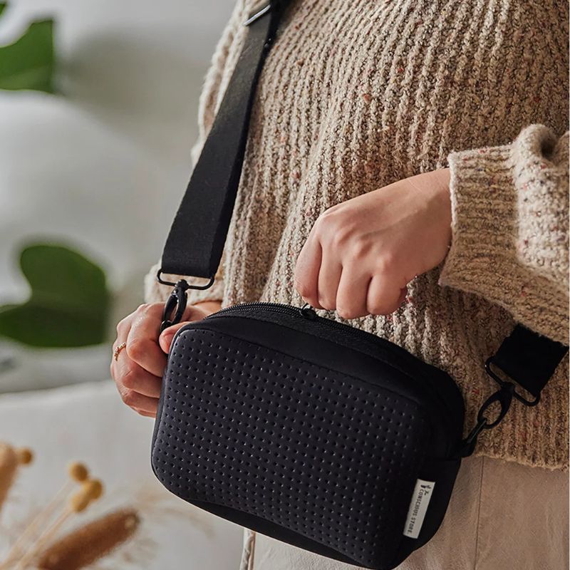 The Conscious Store - recycled neoprene crossbody bag - being opened.