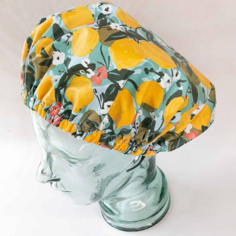 The Laminated Cotton Shop - handmade shower cap - adults - shown on head made from glass.