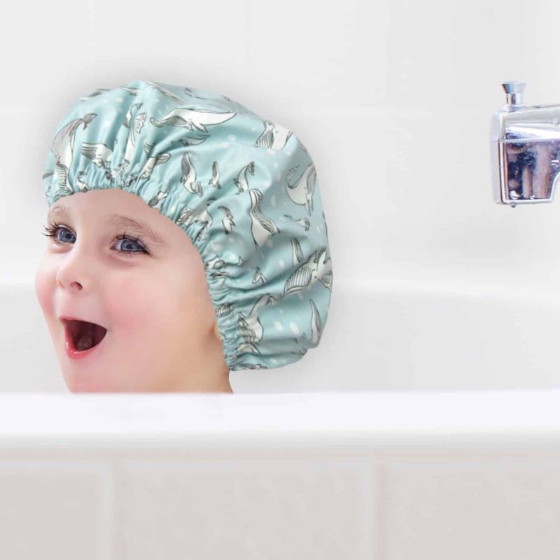 The Laminated Cotton Shop - handmade shower cap for kids - child in bath with cap on.