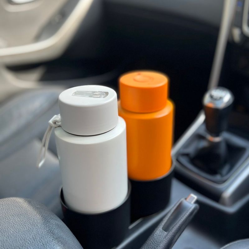 Willy & Bear car cup holder expander - photo in car with 2 Frank Green bottles.