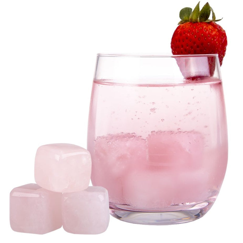 Bartender reusable freezable gin stones in rose quartz - in a glass with a strawberry.