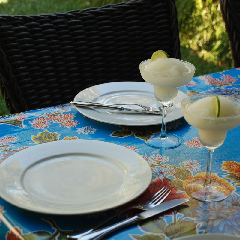    Ben Elke Mexican oilcloth tablecloth on a set table with plates and drinks 