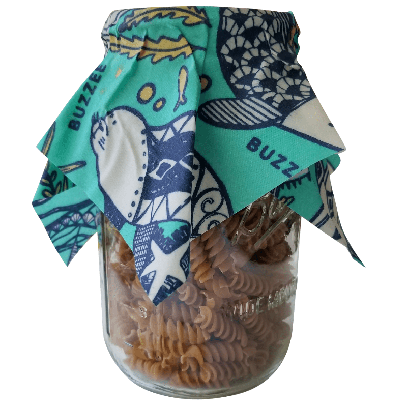 Buzzee organic beeswax wraps box with a set of 4 wraps - Aqua design in use on jar. 