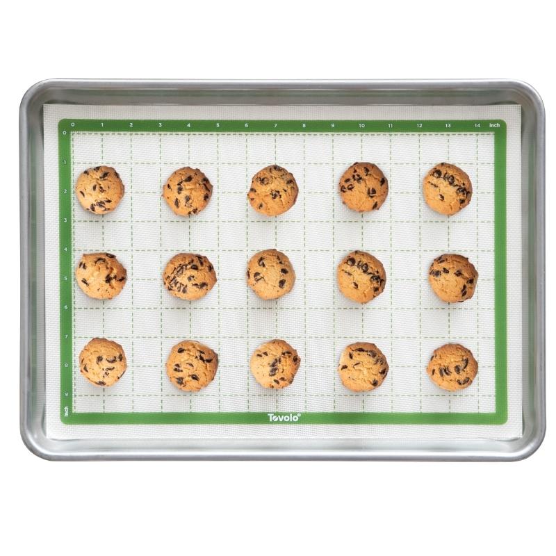 Tovolo pro-grade reusable baking mat in silicone half sheet 42x29cm in Pesto - with cookies on.